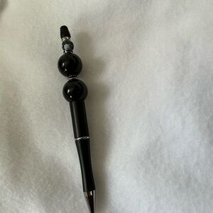 Beaded pen, black ink .